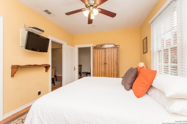 bedroom featuring ceiling fan and hardwood / wood-style flooring