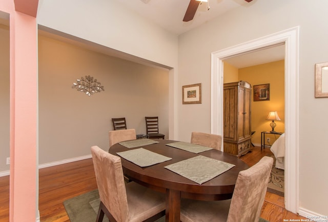 dining space with hardwood / wood-style flooring and ceiling fan