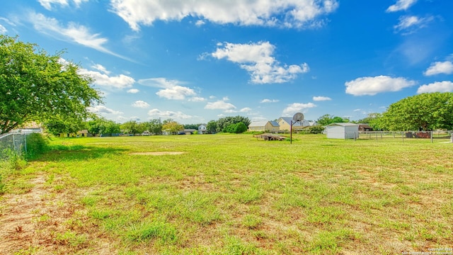 view of yard featuring a storage unit and a rural view