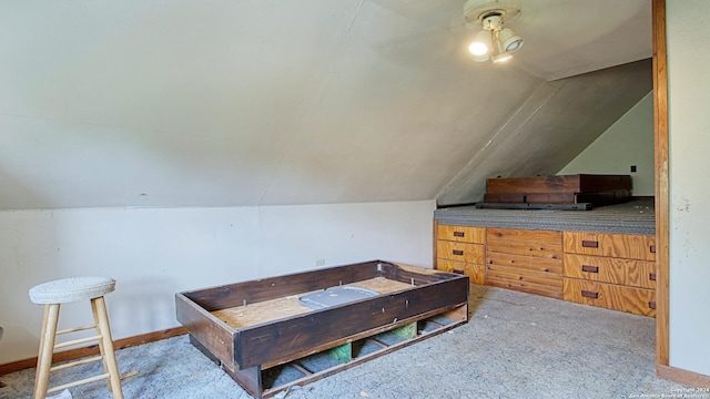 carpeted bedroom with lofted ceiling