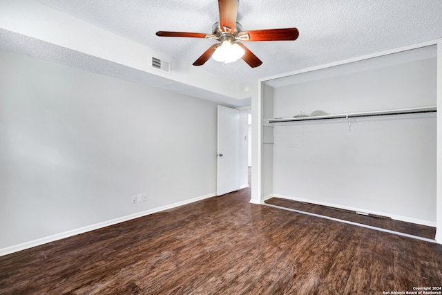 unfurnished room with a textured ceiling, ceiling fan, and dark hardwood / wood-style floors