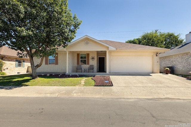 single story home with a front yard and a garage