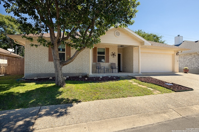 ranch-style house with a garage and a front yard