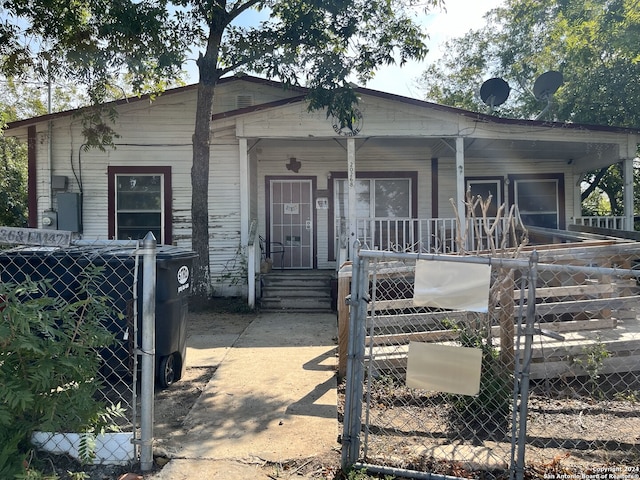 view of front of house with a gate, a fenced front yard, and a porch