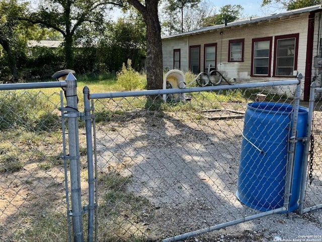 view of gate with central air condition unit