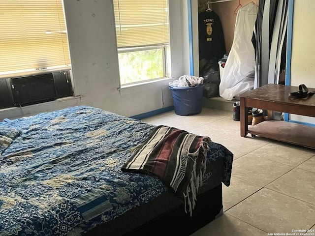 bedroom featuring cooling unit and light tile patterned floors