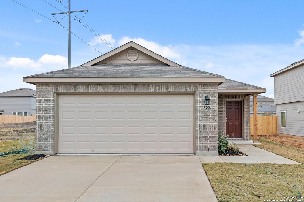 view of front of property with a garage and a front yard