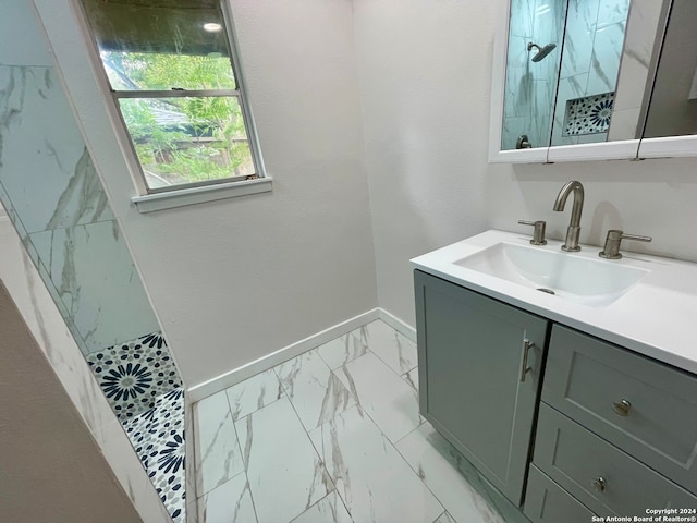 bathroom featuring a shower and vanity