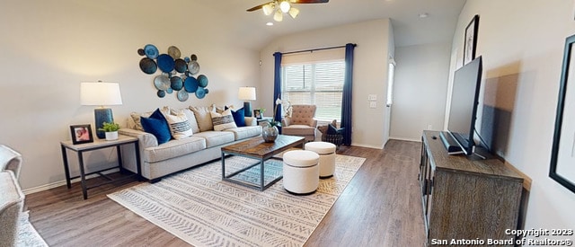 living room with vaulted ceiling, hardwood / wood-style flooring, and ceiling fan