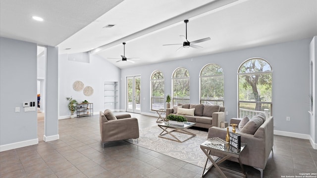 living room with vaulted ceiling with beams, ceiling fan, plenty of natural light, and light tile patterned floors