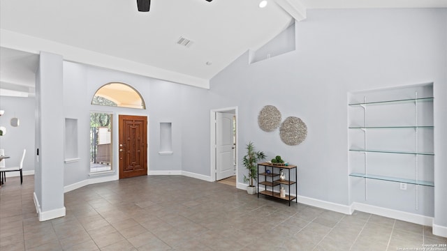 foyer entrance featuring ceiling fan, beamed ceiling, light tile patterned floors, and high vaulted ceiling