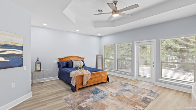 bedroom featuring multiple windows, access to outside, ceiling fan, and light hardwood / wood-style flooring