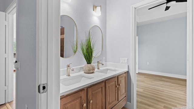 bathroom featuring wood-type flooring, ceiling fan, and vanity