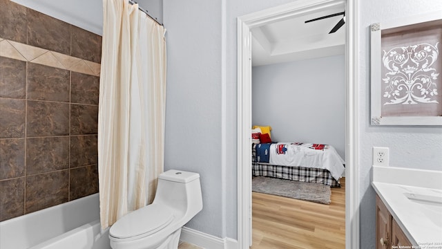 full bathroom featuring ceiling fan, shower / bath combination with curtain, vanity, hardwood / wood-style flooring, and toilet