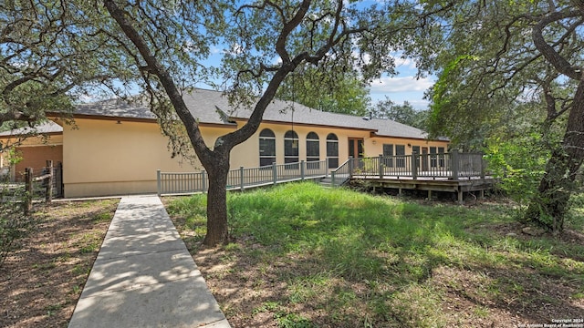 rear view of house with a wooden deck