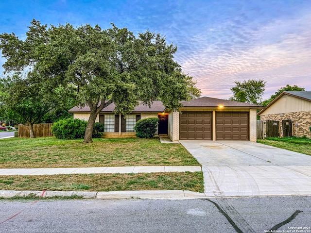 view of front of property featuring a lawn and a garage