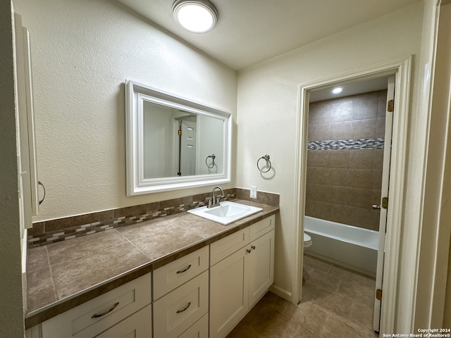 full bathroom with vanity, toilet, and tiled shower / bath combo