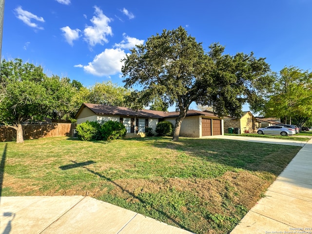 ranch-style home with a garage and a front lawn