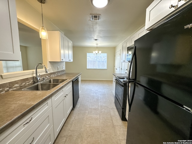 kitchen with black appliances, a notable chandelier, decorative light fixtures, and white cabinets