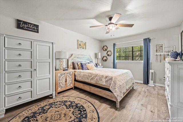 bedroom featuring light wood-type flooring and ceiling fan