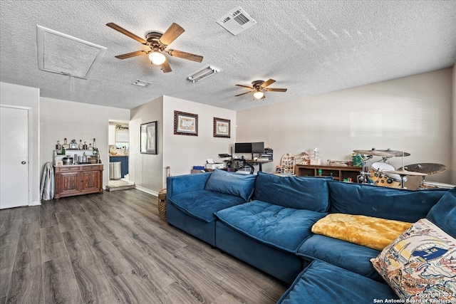 living room featuring a textured ceiling, ceiling fan, and dark hardwood / wood-style floors