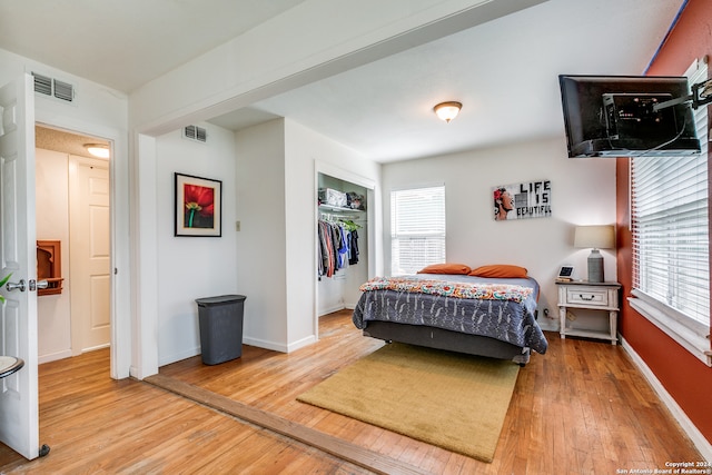 bedroom with hardwood / wood-style floors and a closet