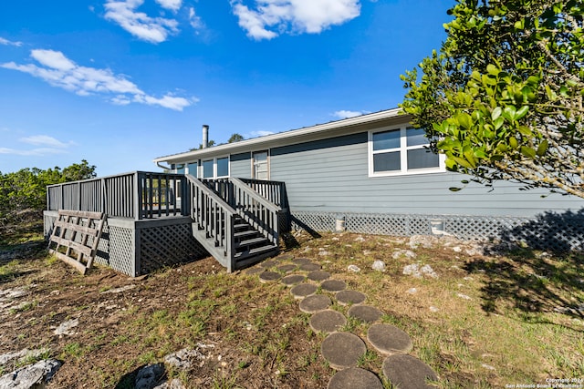 rear view of house featuring a deck