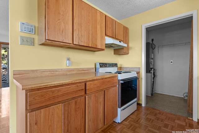 kitchen with white electric stove and a textured ceiling