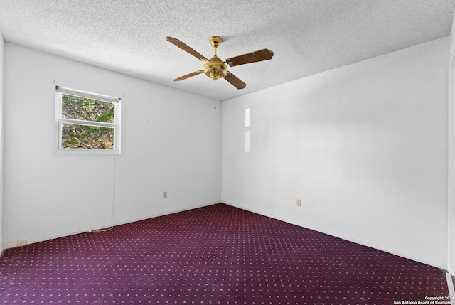 carpeted spare room with a textured ceiling and ceiling fan