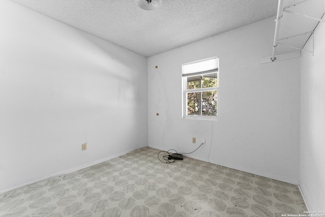 empty room with a textured ceiling