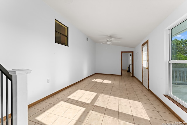 unfurnished room with lofted ceiling, light tile patterned floors, and ceiling fan