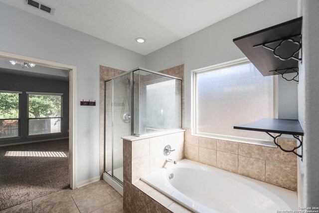 bathroom with separate shower and tub and tile patterned floors