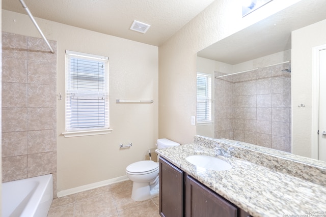 full bathroom featuring tiled shower / bath combo, toilet, a wealth of natural light, and vanity