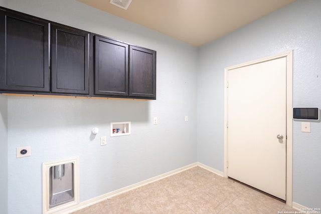 laundry area featuring hookup for a washing machine, cabinets, light tile patterned floors, hookup for an electric dryer, and hookup for a gas dryer