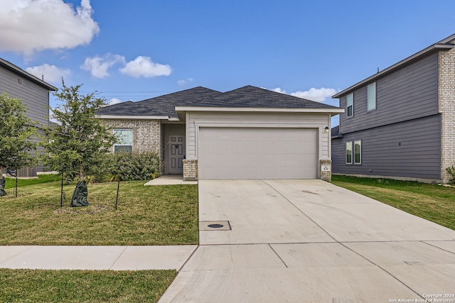 view of front of house with a front yard and a garage