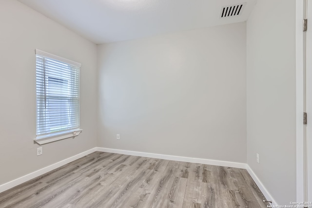 unfurnished room with light hardwood / wood-style floors