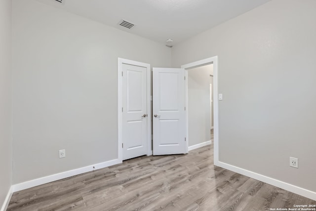 unfurnished bedroom featuring light wood-type flooring