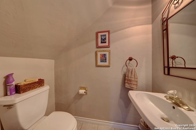 bathroom featuring tile patterned flooring, toilet, and sink