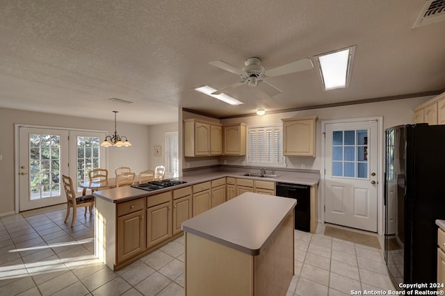 kitchen with ceiling fan with notable chandelier, black appliances, a kitchen island, and hanging light fixtures