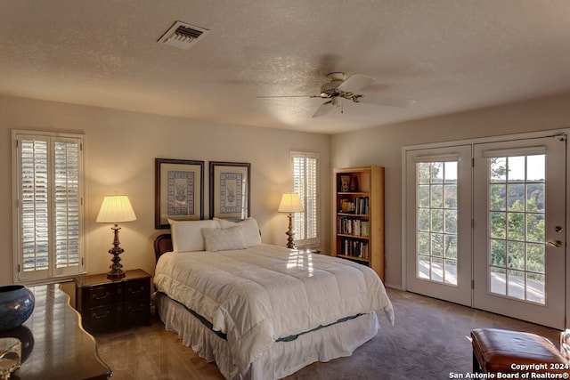 bedroom with carpet, ceiling fan, access to exterior, and a textured ceiling