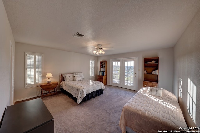 bedroom featuring a textured ceiling, carpet flooring, ceiling fan, and access to outside