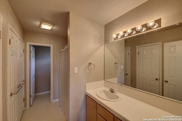 bathroom featuring vanity and a textured ceiling