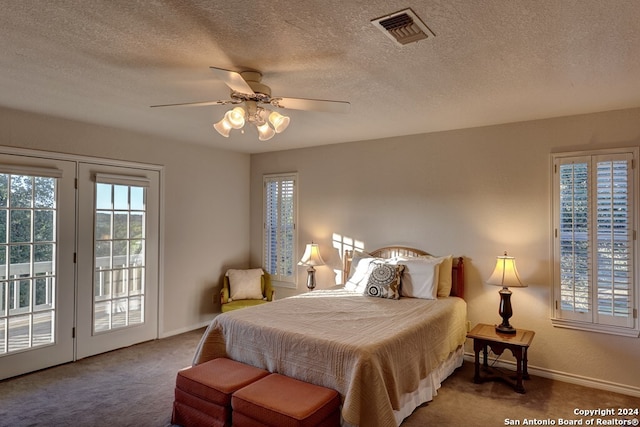 carpeted bedroom featuring a textured ceiling, ceiling fan, and access to outside