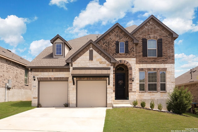 view of front facade with a garage and a front lawn