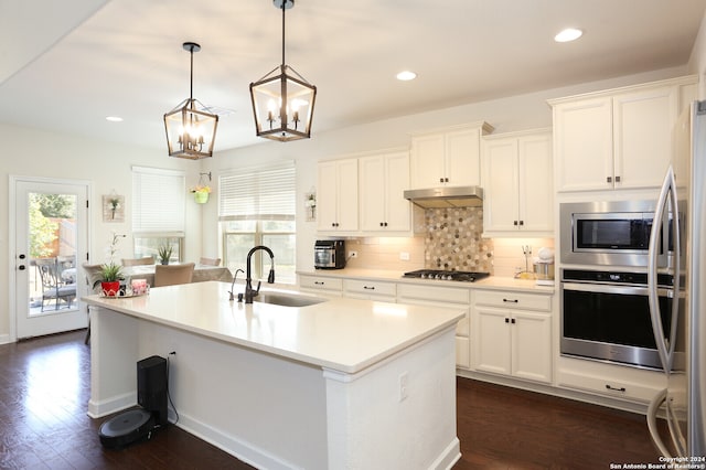 kitchen featuring plenty of natural light, sink, appliances with stainless steel finishes, and an inviting chandelier