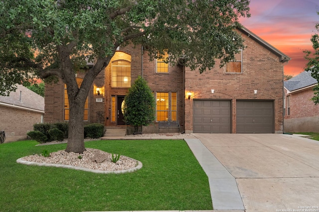 front facade with a lawn and a garage