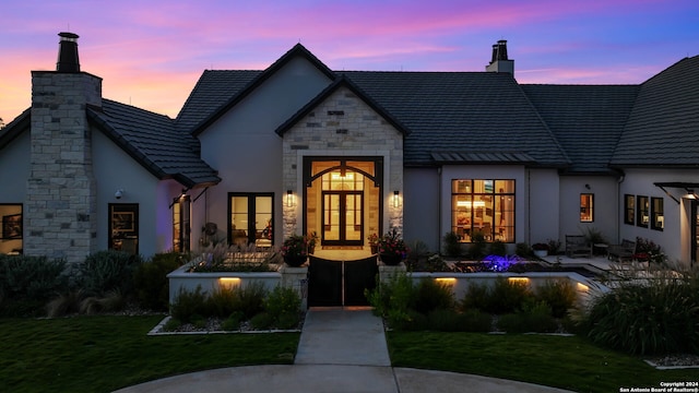 french country home featuring a yard