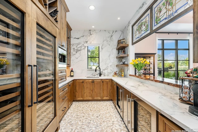 kitchen with brown cabinets, open shelves, light stone counters, recessed lighting, and decorative backsplash