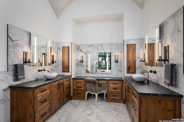 bathroom with vanity and high vaulted ceiling