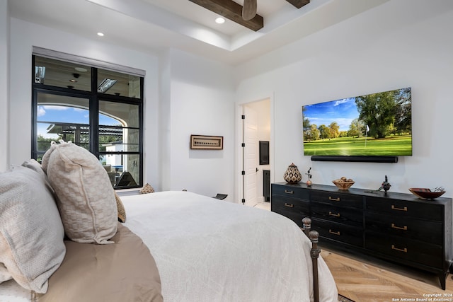 bedroom with access to outside, connected bathroom, ceiling fan, light parquet floors, and beam ceiling